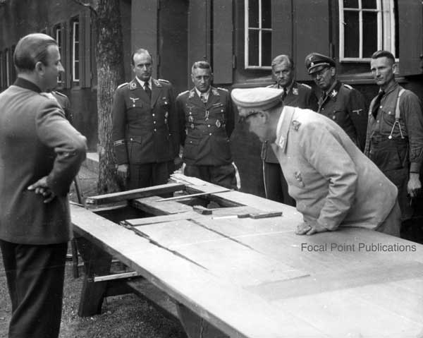 Hermann G&ouml;ring inspects the table damaged by the traitors' bomb